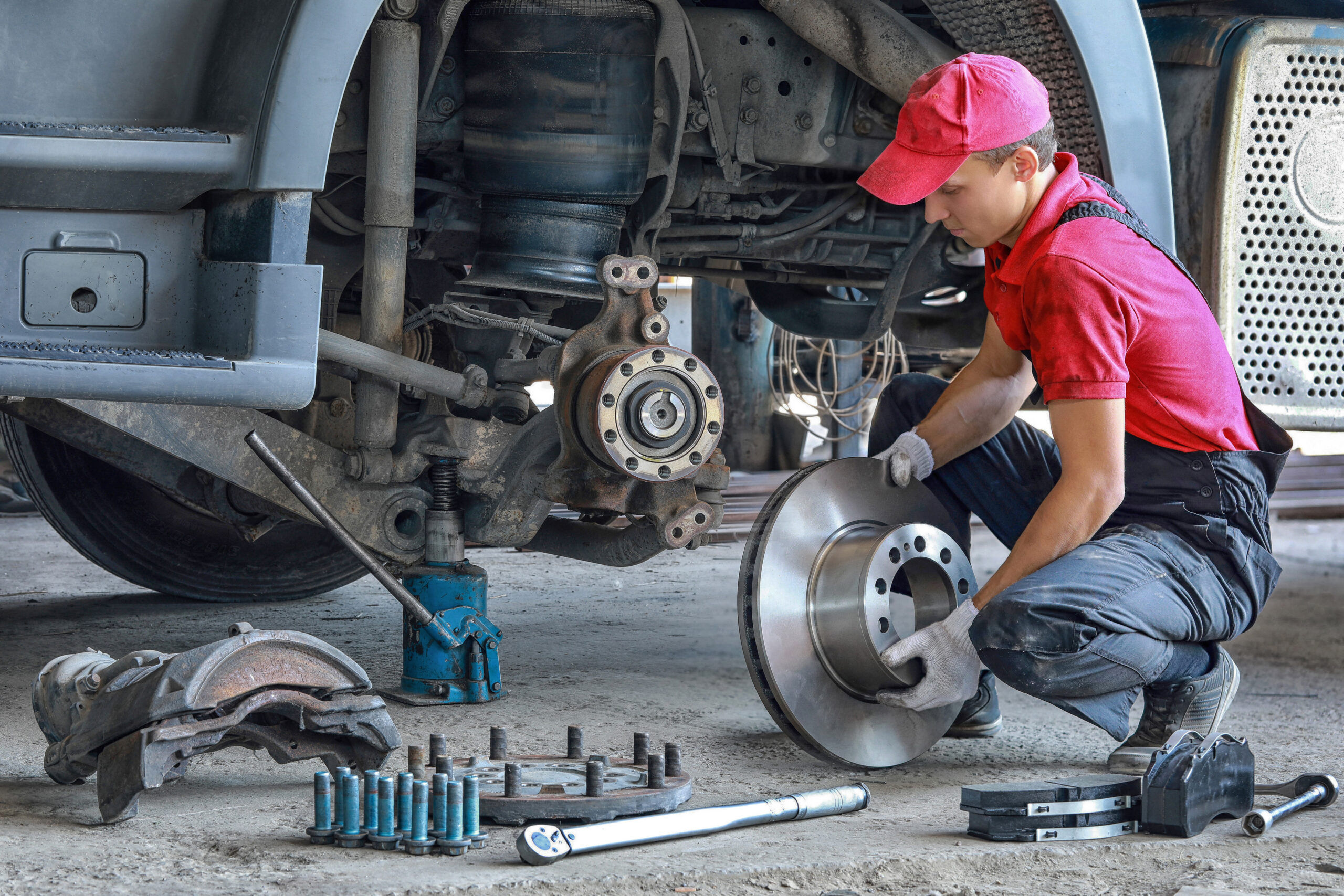 Track mechanic works on a wheel