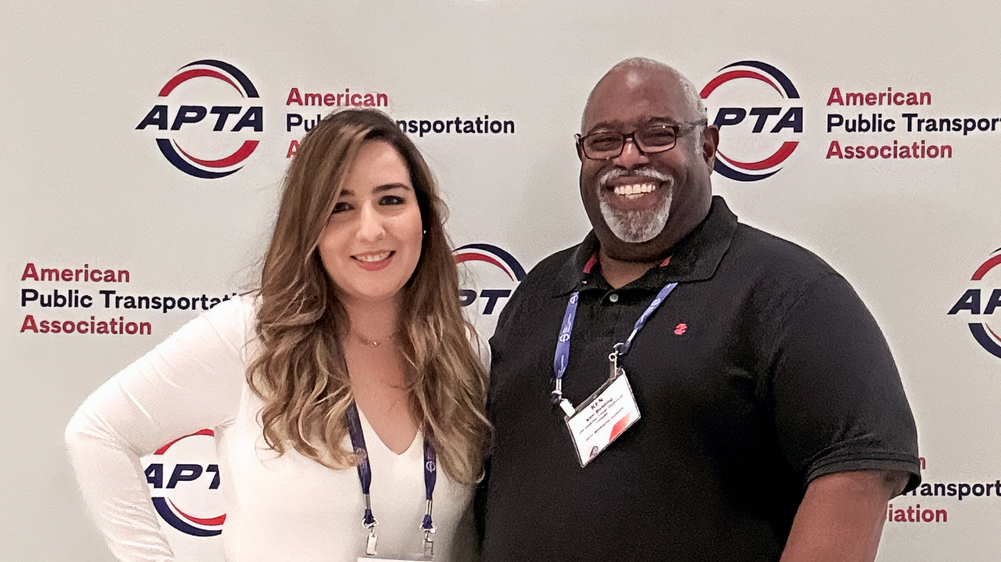 Valeria Diaz Venegas and Ken Bolding stand in front of an APTA backdrop